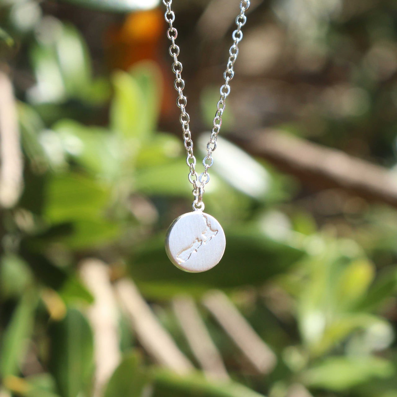 Round New Zealand/Aotearoa Map Necklace